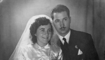 Vintage image from the late 40s : Young couple posing for studio portrait at their wedding day