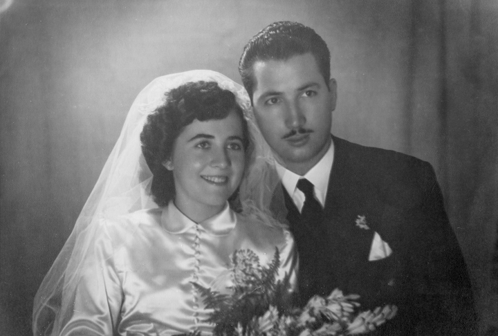 Vintage image from the late 40s : Young couple posing for studio portrait at their wedding day