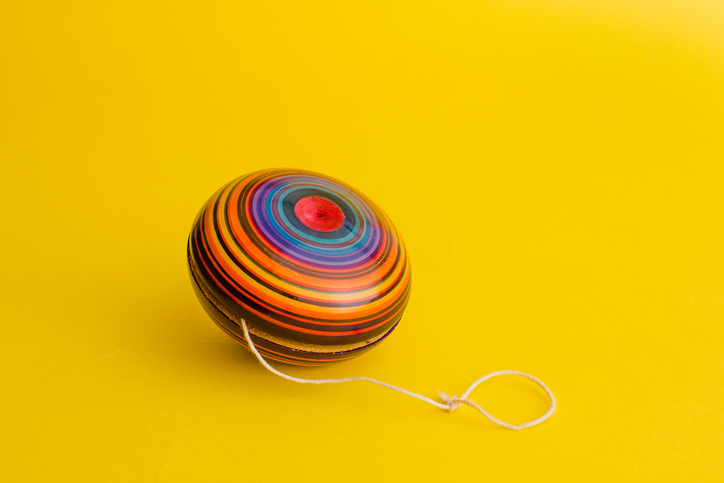 mexican toys from Wooden, balero, yoyo and trompo in Mexico on a yellow background