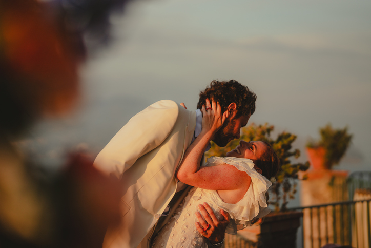 Romantic couple, kissing at sunset