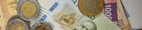 Many mexican pesos bills spread randomly over a flat surface