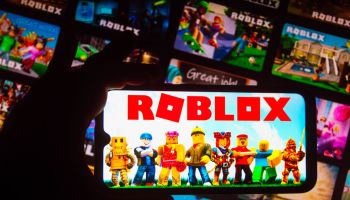 In this photo illustration the Roblox logo seen displayed on...