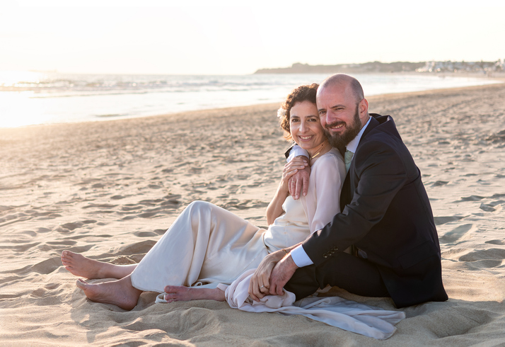 Bride and groom enjoying the beach at sunset