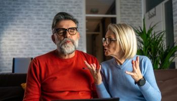 woman quarrels and yells at the loser's husband
