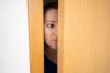 woman spying and entering through the door